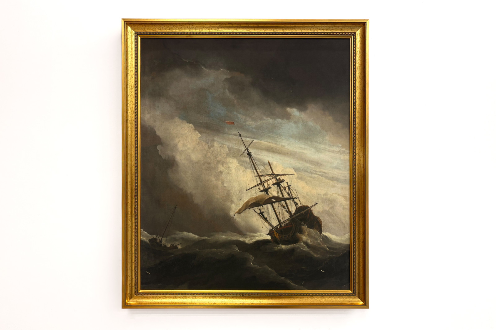 Et skip på åpent hav tatt av en vindbyge, kjent som «Vindkastet» - Willem van de Velde (II)
