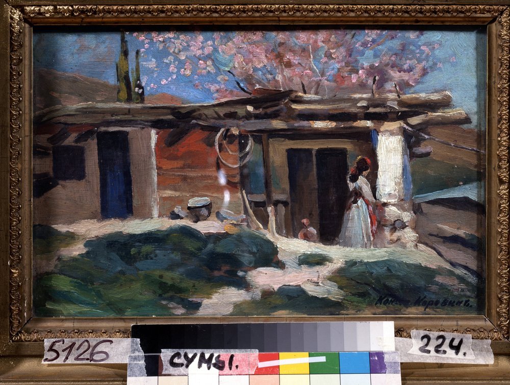 Krim, mandeltrær i blomst. (Krim, blomstrende mandeltrær). Ung kvinne foran et lite trehus, under rosa mandeltrær. Maleri av Konstantin Alexeyevich Korovin (Constantin Korovin) (1861-1939), olje på lerret av Konstantin Alekseevich Korovin