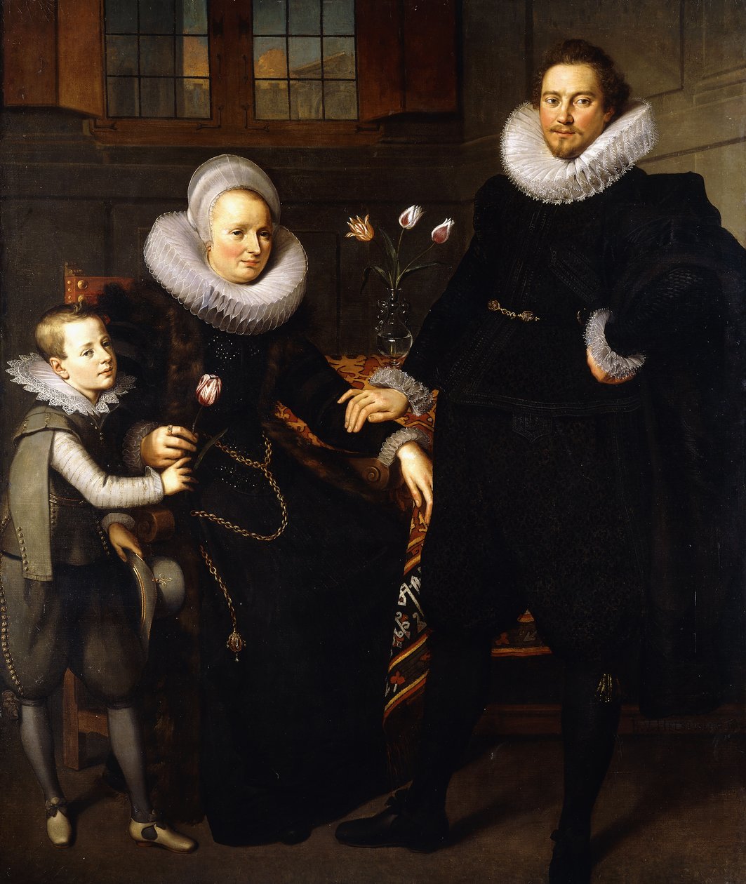 Et gruppeportrett av en familie, i full lengde, i et interiør av Adam van Noort