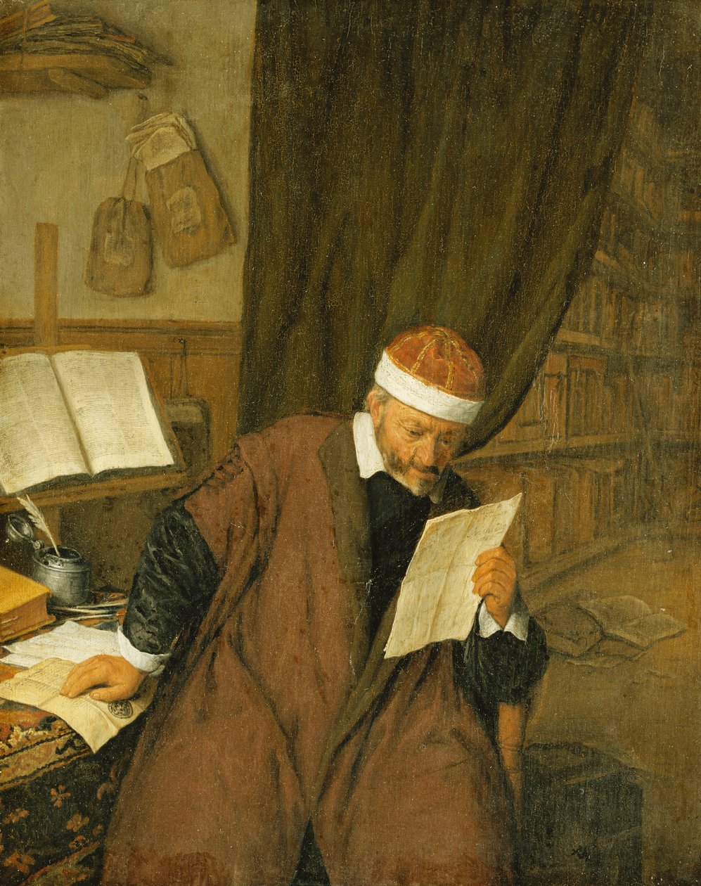 En advokat som sitter ved et skrivebord og leser et brev, et bibliotek bortenfor, 1668 av Adriaen Jansz. van Ostade