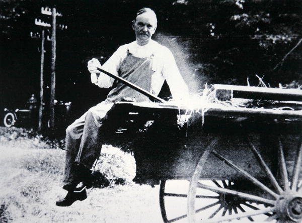 President Calvin Coolidge (1873-1933) poserer som bonde under en ferie i Vermont (s/hv-bilde) av American Photographer