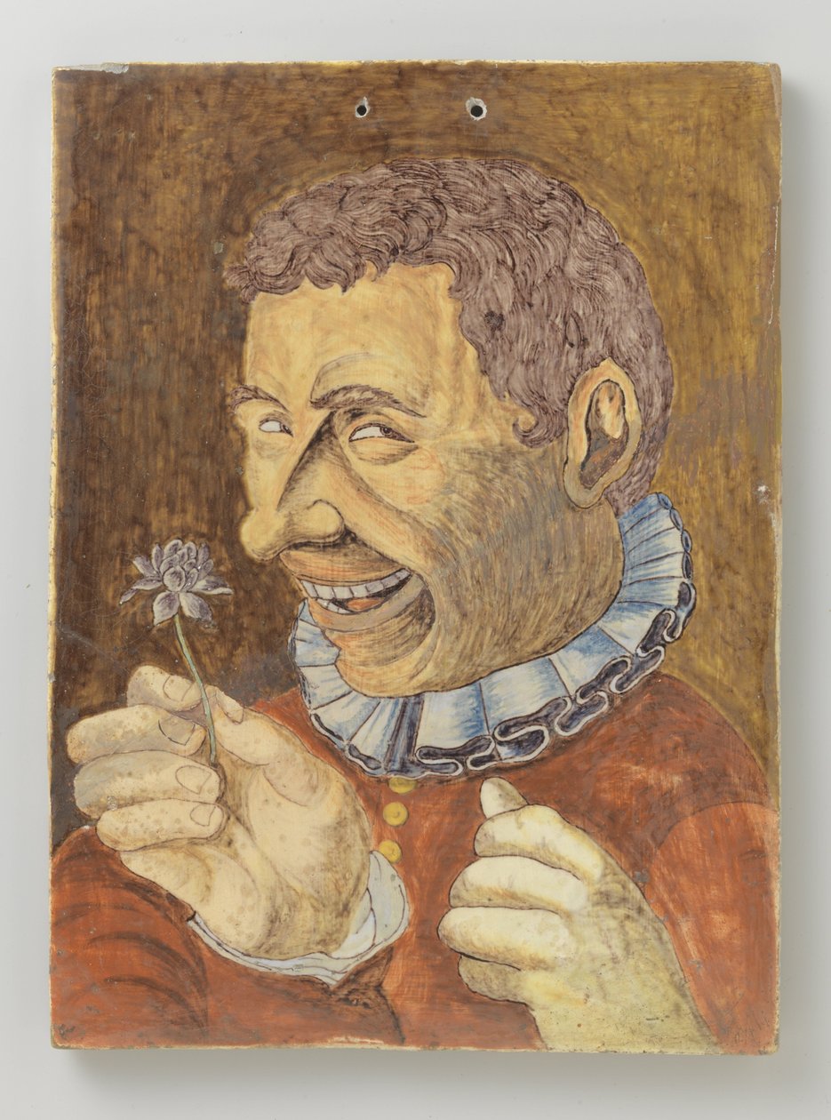 tallerken av fajanse med mann med blomst av Anonymous