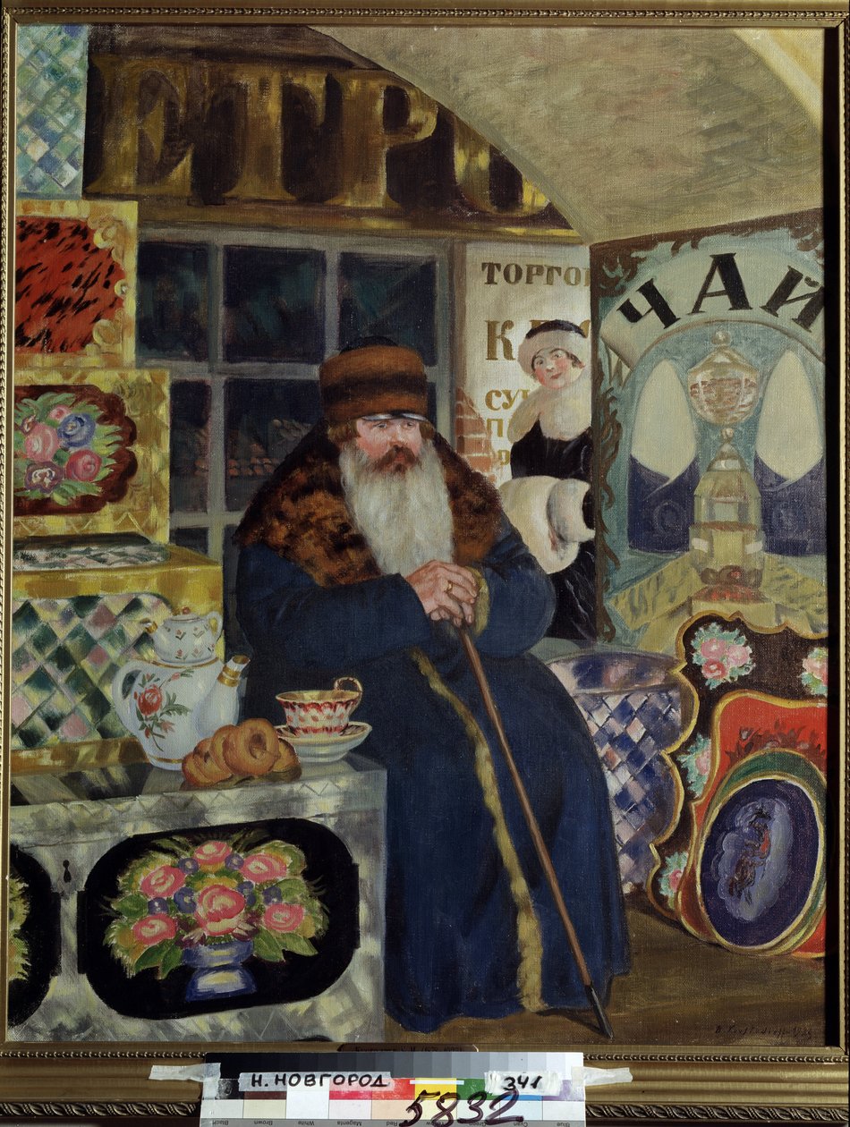 En kjøpmann av malte esker (A Bags Merchant). En mann kledd i en tykk frakk med bred pelskrage, venter i nærheten av varene sine, med tekanne, med kaker på siden. Bak ham, i handlegatet, smiler en elegant kvinne. Maling av Boris Mikhailovich Kustodiev