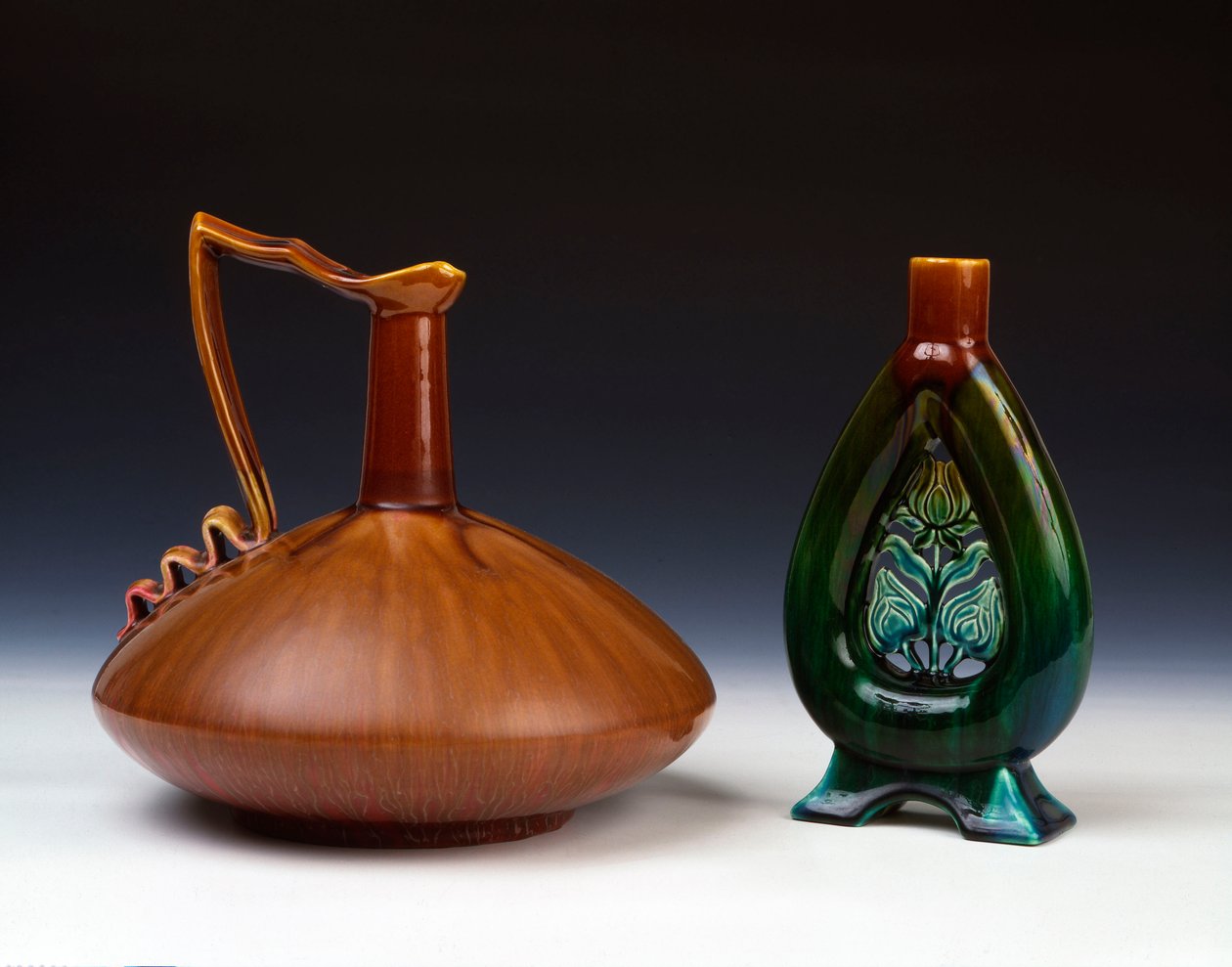 En Linthorpe keramikkmugge av komprimert kuleform med stripete karamell, grønn og crimson glasur og en Linthorpe Pottery vase med gjennomhullet blomsterknoppdekor og flekkete grønne, blå og brune glasurer av Christopher Dresser