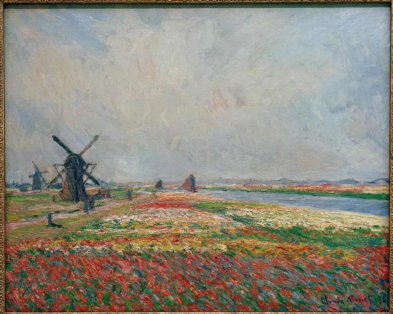 Åker med blomster og vindmøller nær Leiden av Claude Monet