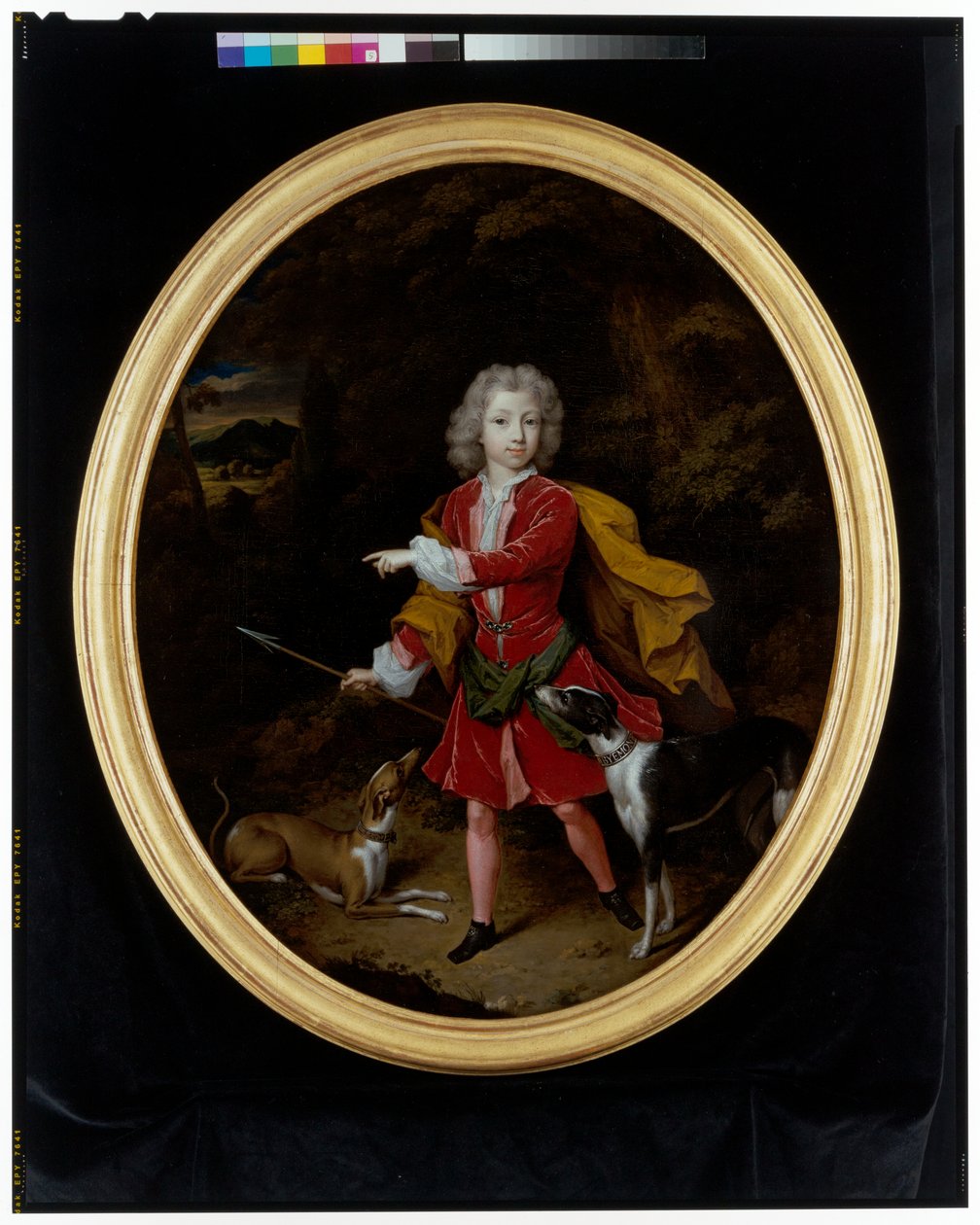 Et portrett av en ung mann med et par jakthunder i et skogslandskap av Constantin Netscher