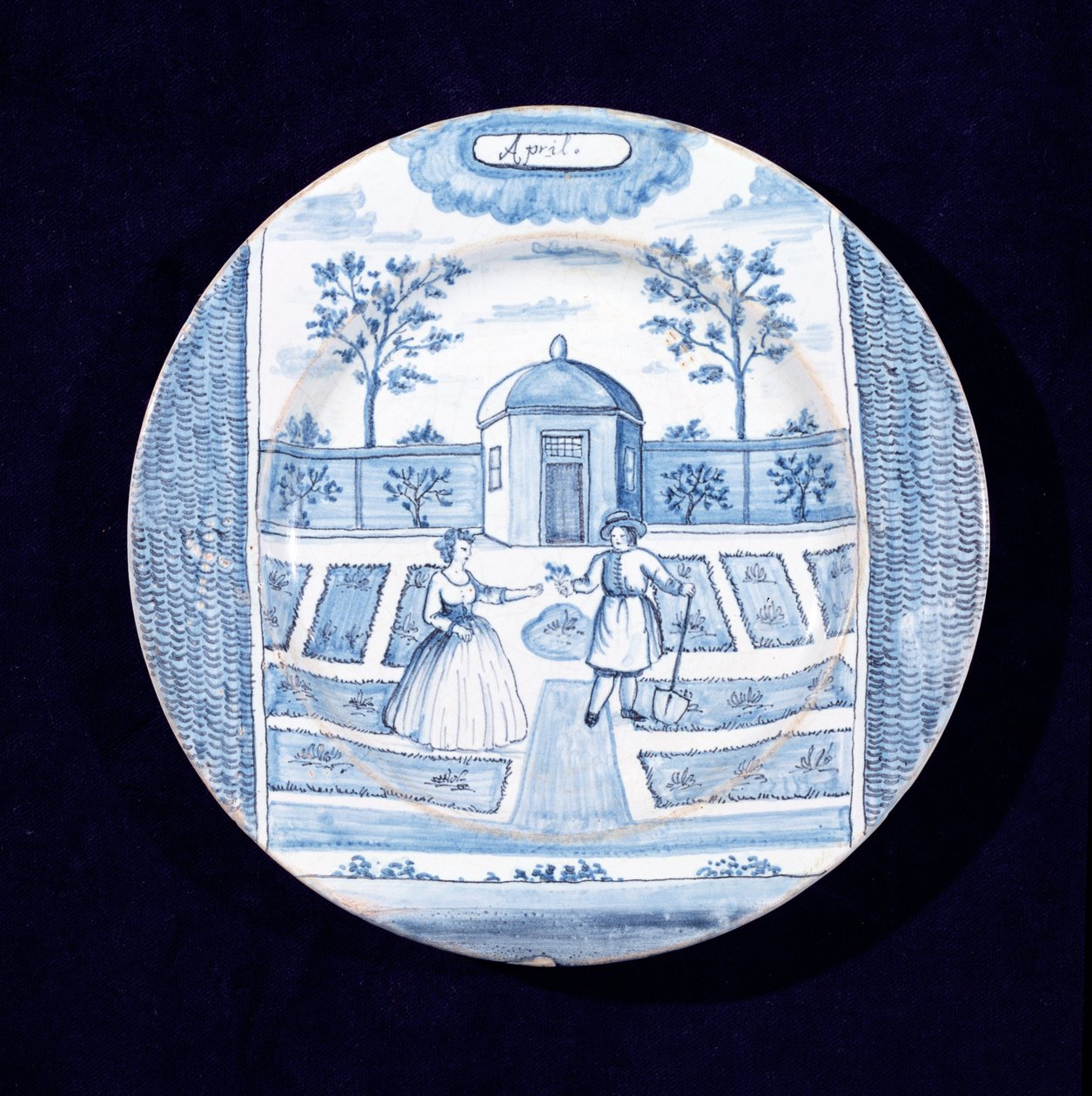 Delftvareplate som viser april måned (tinnglasert lertøy) av Dutch School