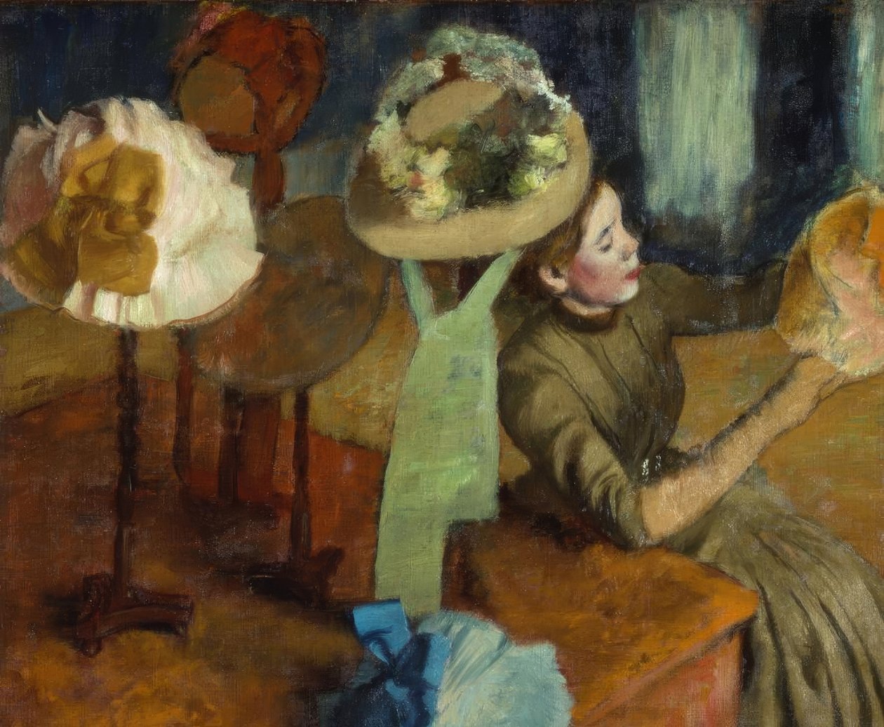 Hos hattemakeren av Edgar Degas