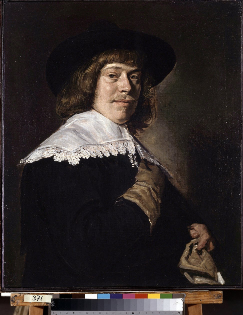 Portrett av en mann som holder en hanske. Portrett av en ung mann som holder en hanske. Maleri av Frans Hans Hals I (1581-1666), ca 1650. Olje på lerret. Nederlandsk kunst, barokkstil. Eremitasjemuseet, St. Petersburg. av Frans Hals