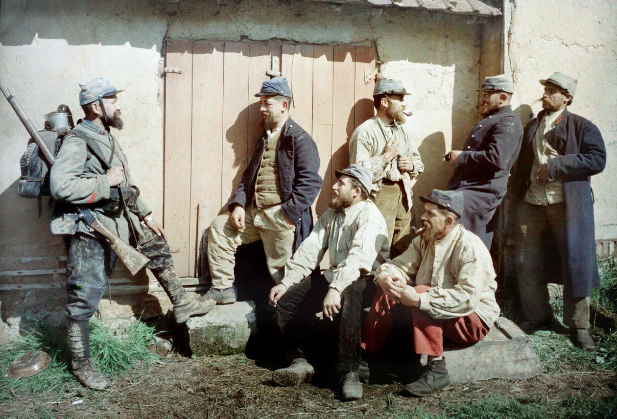 Sju franske soldater foran en bygning, en bærer våpenet og utstyret hans, Frankrike, ca. 1914-18 (autokrom) av French Photographer