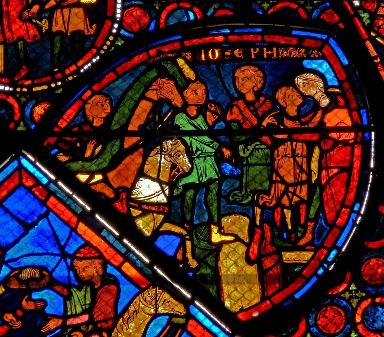 Vindu w24 som viser en scene fra historien om Josef: brødrene hans ankommer og Josef omfavner Benjamin av French School