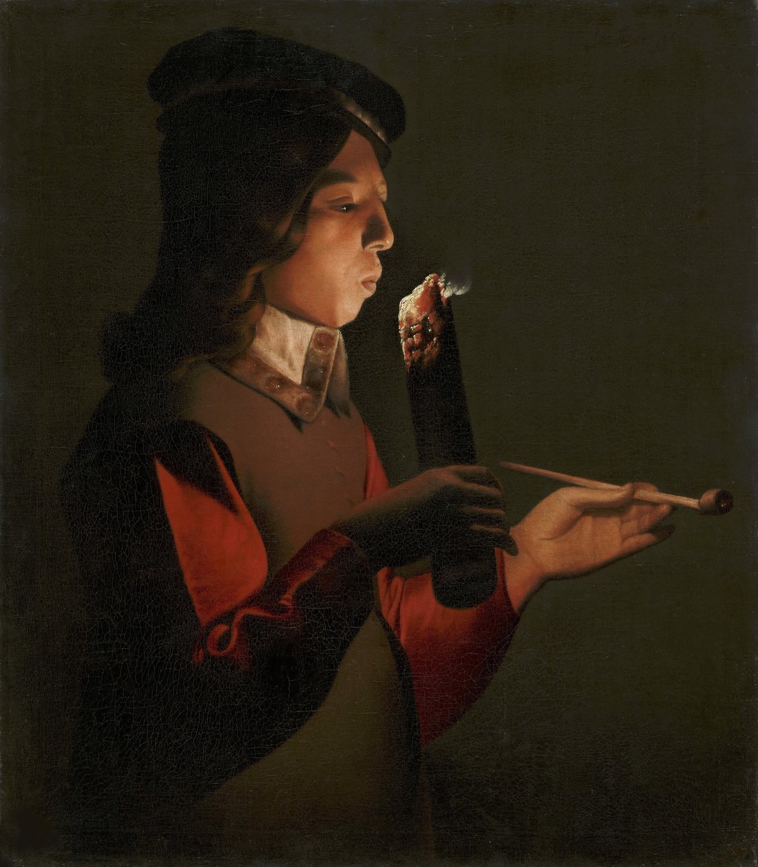 En ung gutt med en pipe, som blåser på et ildsted, av La Tour, Georges, de (1583-1652). olje på lerret av Georges de La Tour
