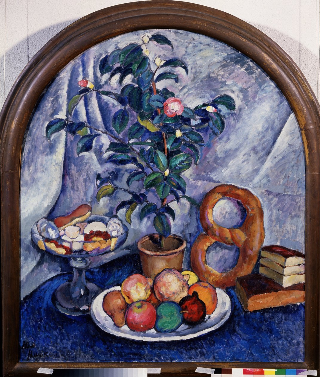 Stilleben. Camellia (Still Life. Camellia). Frukt, bakverk og en stabel med bøker under en potteplante. Maleri av Ilya Ivanovich Mashkov (Ilia Mashkov, Matchkov) (1881-1944), olje på lerret av Ilya Ivanovich Mashkov