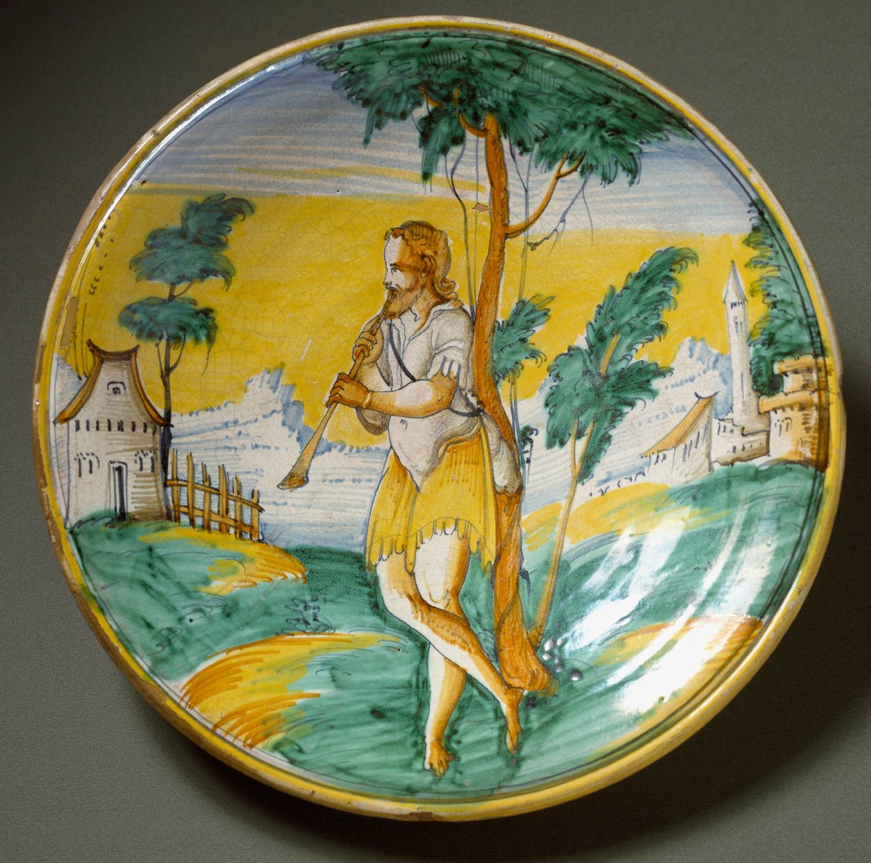Fløytespiller i et landskap. Keramisk plate produsert i Viterbo, Italia. Slutten av 1500-tallet Firenze, Museo Nazionale del Bargello av Italian School