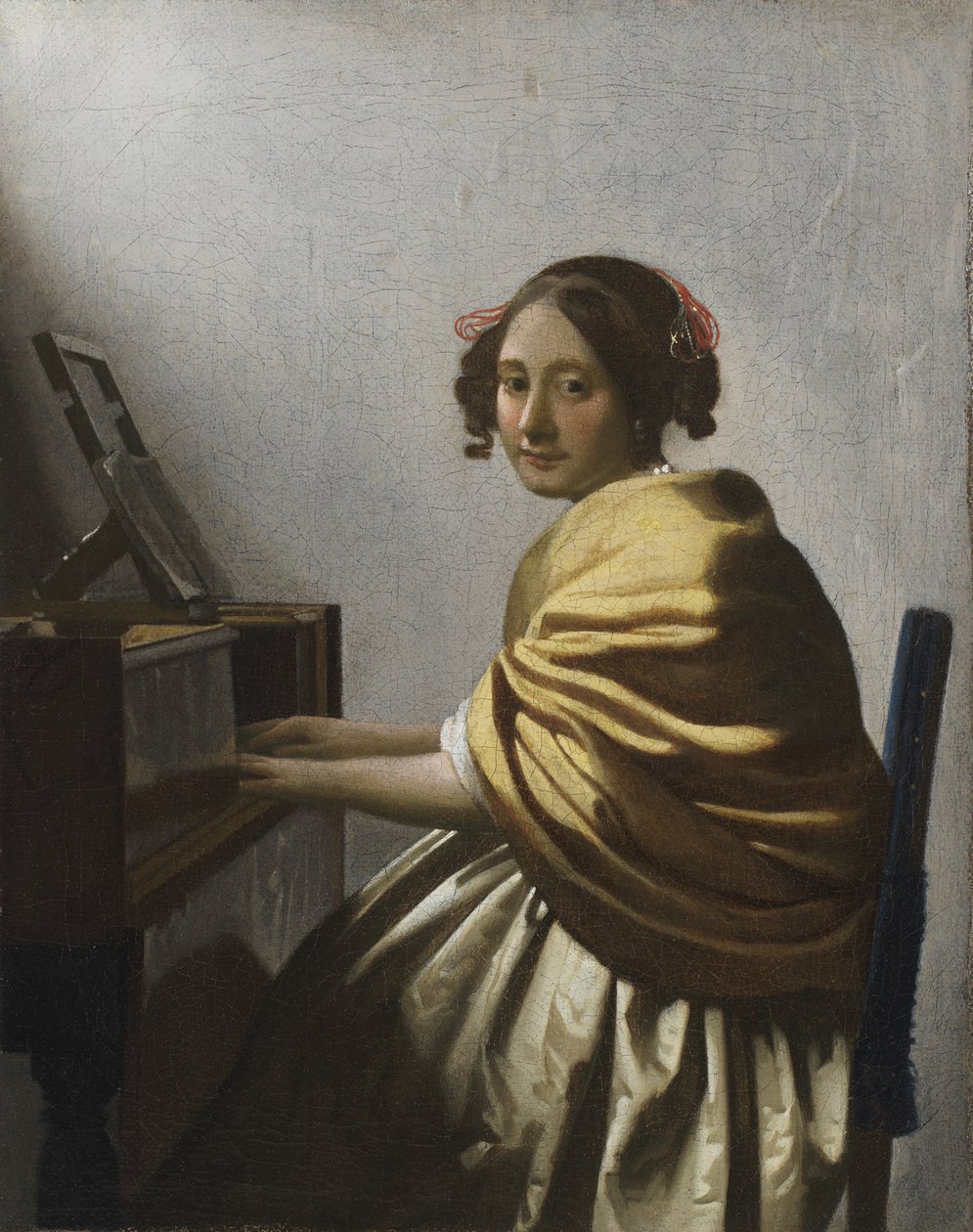En ung kvinne som sitter på en Virginal, ca. 1670 av Jan Vermeer van Delft