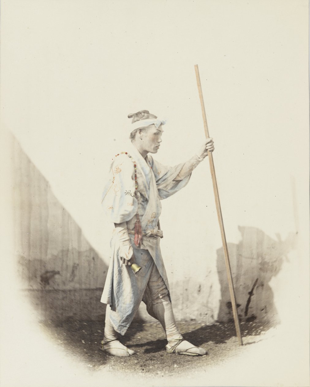 Japansk mann med bjelle (håndfarget svart/hvitt-bilde) av Japanese Photographer
