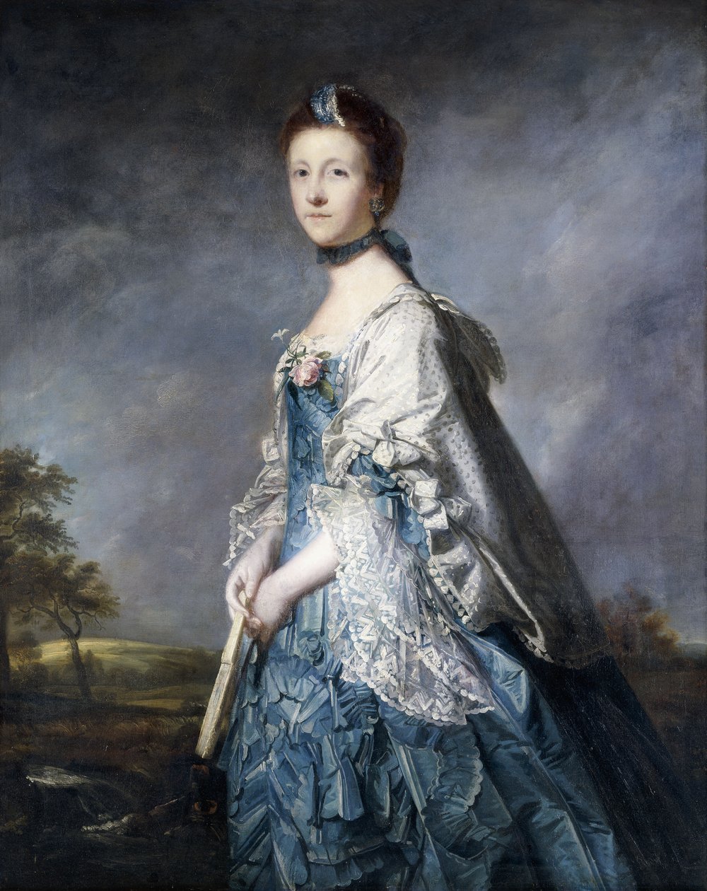Portrett av Anne, grevinne Winterton, stående trekvart lengde, iført en blå kjole, og blondetrimmet sjal, holder en vifte, i et landskap, av Joshua Reynolds