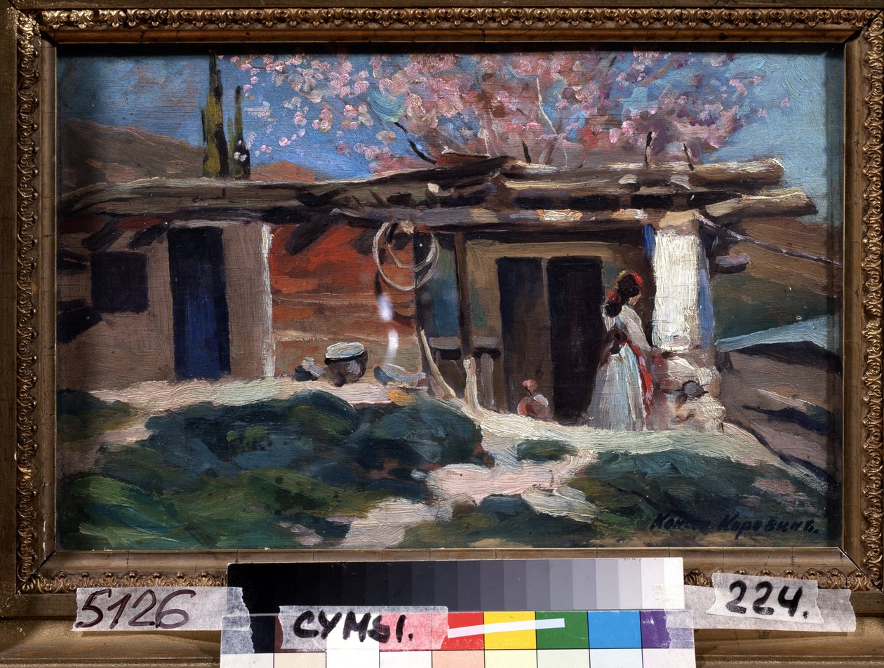 Krim, mandeltrær i blomst. (Krim, blomstrende mandeltrær). Ung kvinne foran et lite trehus, under rosa mandeltrær. Maleri av Konstantin Alexeyevich Korovin (Constantin Korovin) (1861-1939), olje på lerret av Konstantin Alekseevich Korovin