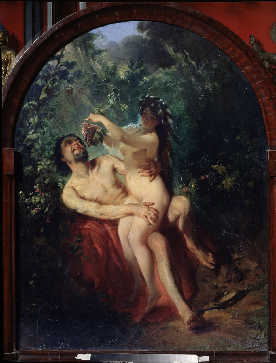 Satyr og nymfe. (Satyr og nymfe). Nakent og beruset par, nymfen på knærne til satyren mater ham med en klase druer, plukket fra vinstokkene som omgir dem. Maleri av Konstantin Yegorovich Makovsky (Constantin Makovsky) (1839-1915), olje av Konstantin Egorovich Makovsky