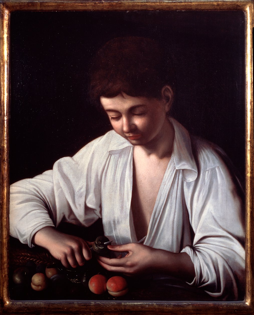 En gutt som skreller en frukt av Michelangelo Merisi da Caravaggio