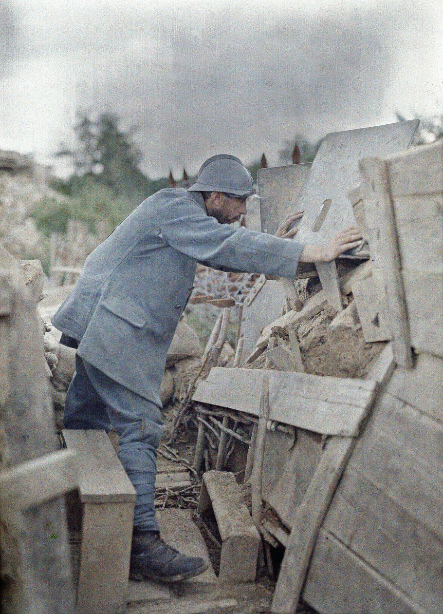 En fransk soldat i hærens utkikkspost 26 ser på området foran seg gjennom et beskyttende metallskjold, Eglingen, Department Haut-Rhin, Alsace, Frankrike, 26. juni 1917 (autokrom) av Paul Castelnau