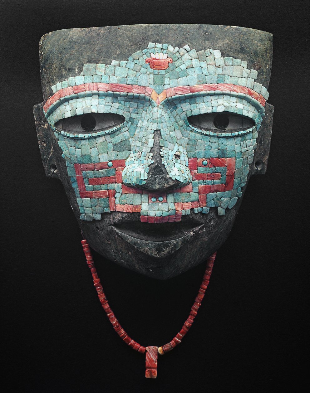 Begravelsesmaske dekket av turkis og rød skallmosaikk. Artefakt fra Teotihuacan, Mexico City. Teotihuacan Civilization - Precolombian kunst: begravelsesmaske av turkise og rosa steiner fra sivilisasjonen Teotihuacan III (300-650 e.Kr.) Mexico. Mexi av Pre Columbian Pre Columbian