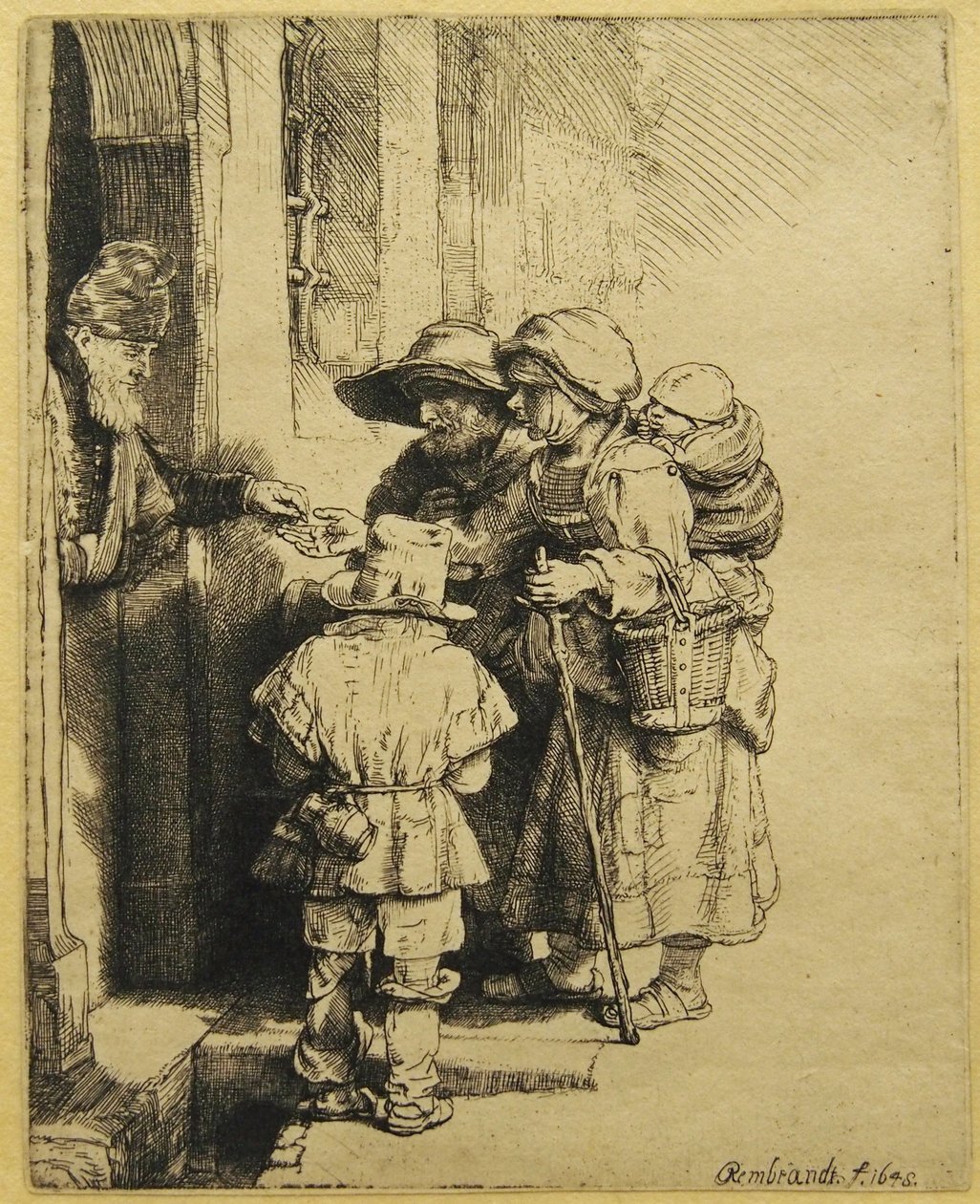 En blind, robust spiller og familie som mottar almisser av Rembrandt van Rijn