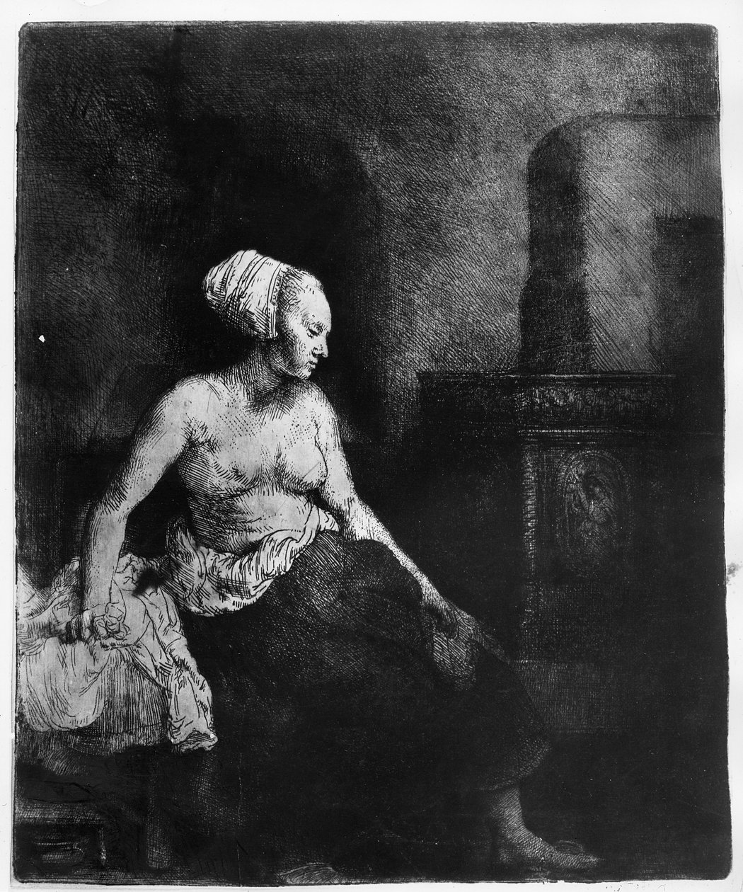 Kvinne som sitter halvkledd ved siden av en komfyr, 1658 av Rembrandt van Rijn