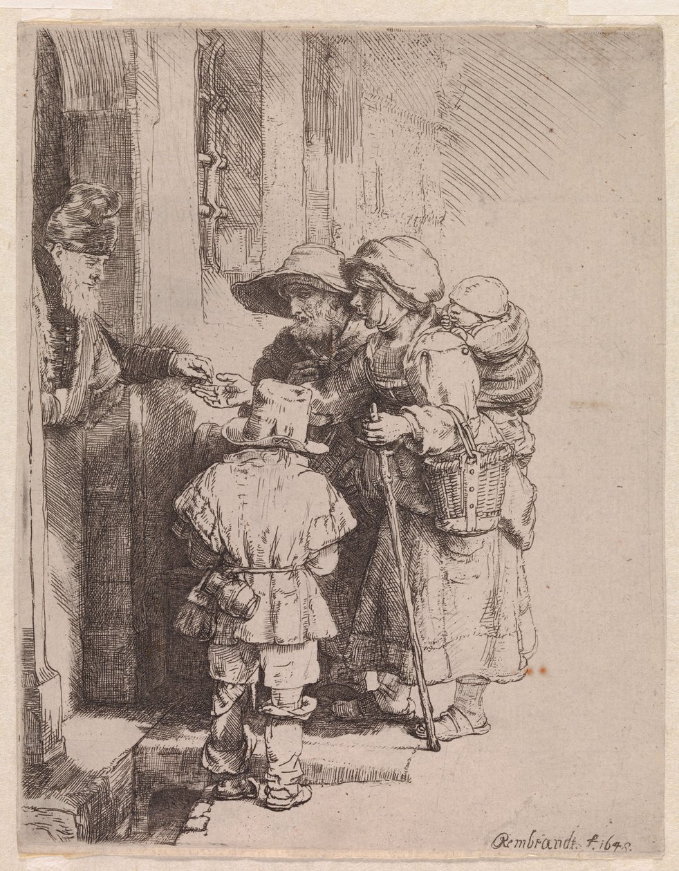 En tiggerfamilie som mottar almisser av Rembrandt van Rijn