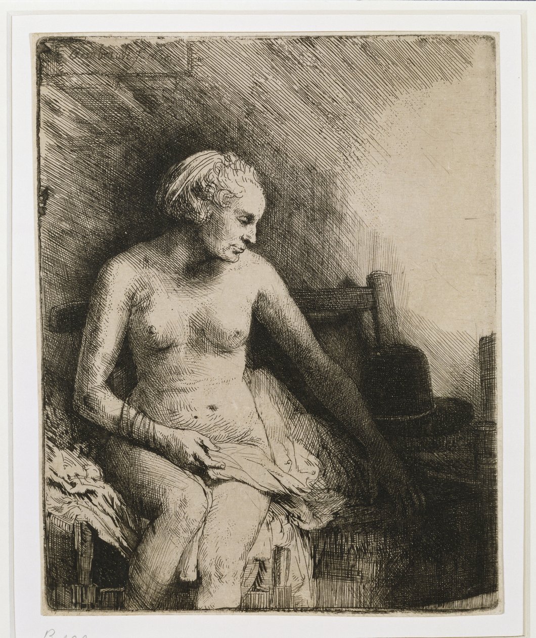 En kvinne ved badet med en hatt ved siden av seg, 1658 av Rembrandt van Rijn