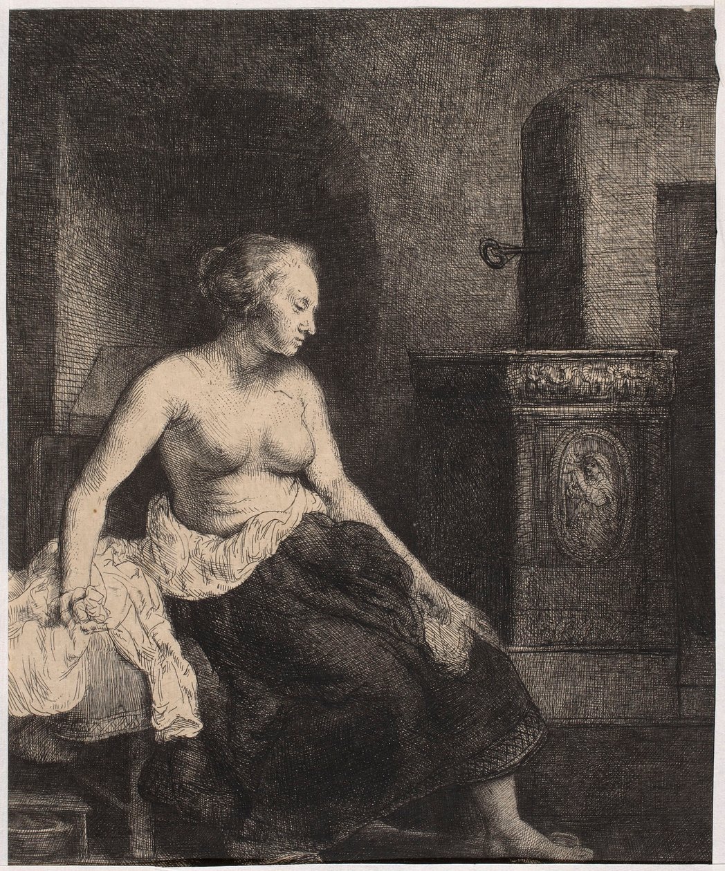 En halvnaken kvinne som sitter ved ovnen av Rembrandt van Rijn