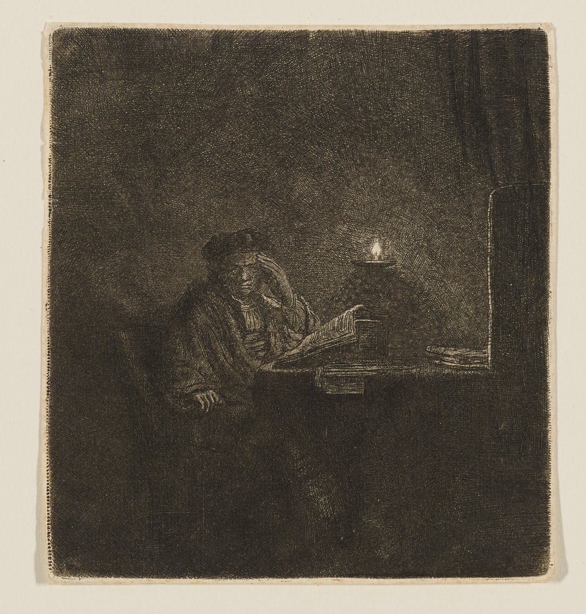 En student ved et bord i stearinlysets skinn av Rembrandt van Rijn