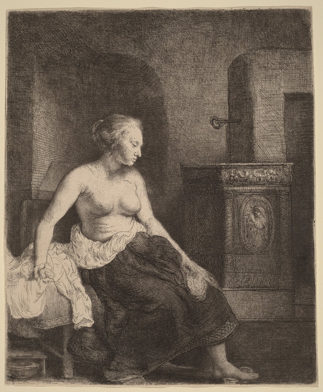 Kvinne som sitter halvkledd ved siden av en ovn av Rembrandt van Rijn