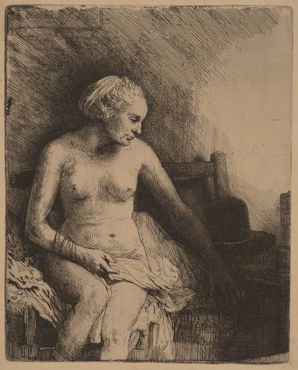 Kvinne ved badekaret med en hatt ved siden av seg av Rembrandt van Rijn