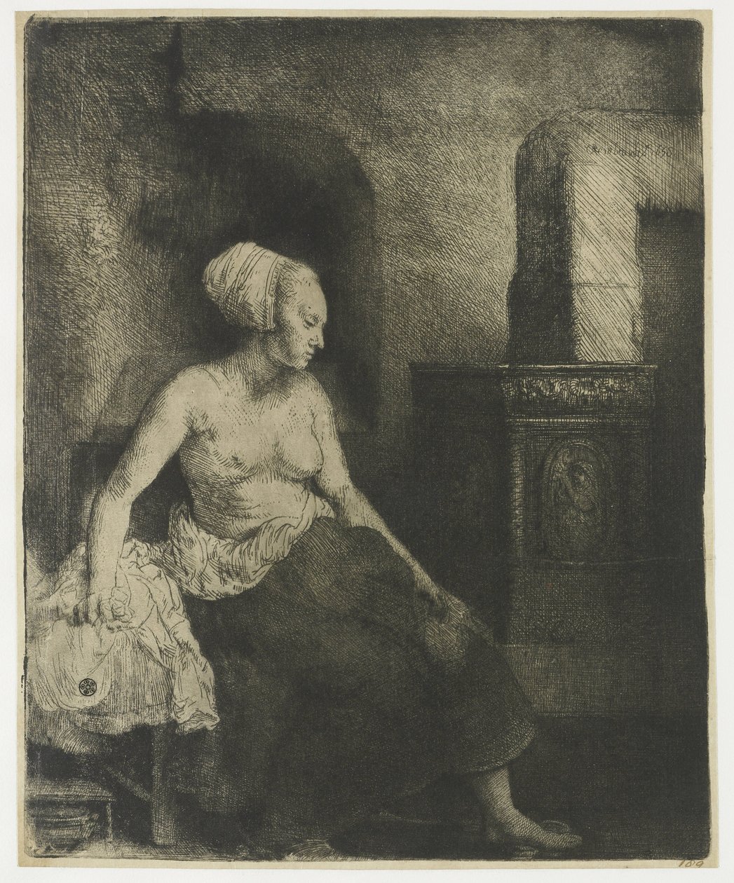 Kvinne som sitter halvkledd ved siden av en komfyr av Rembrandt van Rijn