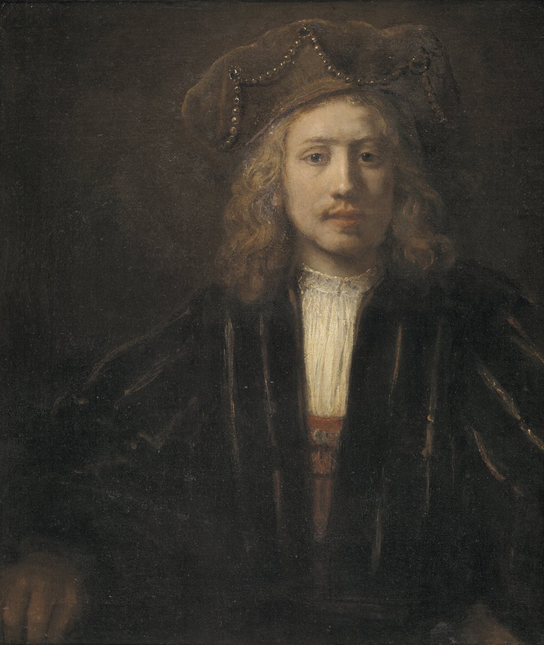 Ung mann i en perle-trimmet lue av Rembrandt van Rijn