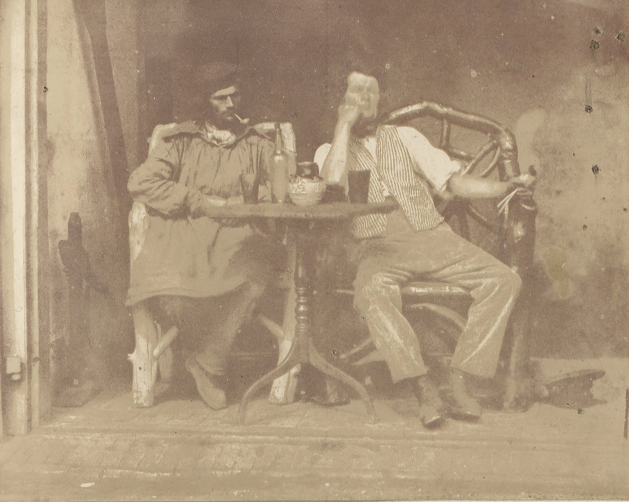 To menn sitter ved et bord, 1850-tallet. av Unbekannt