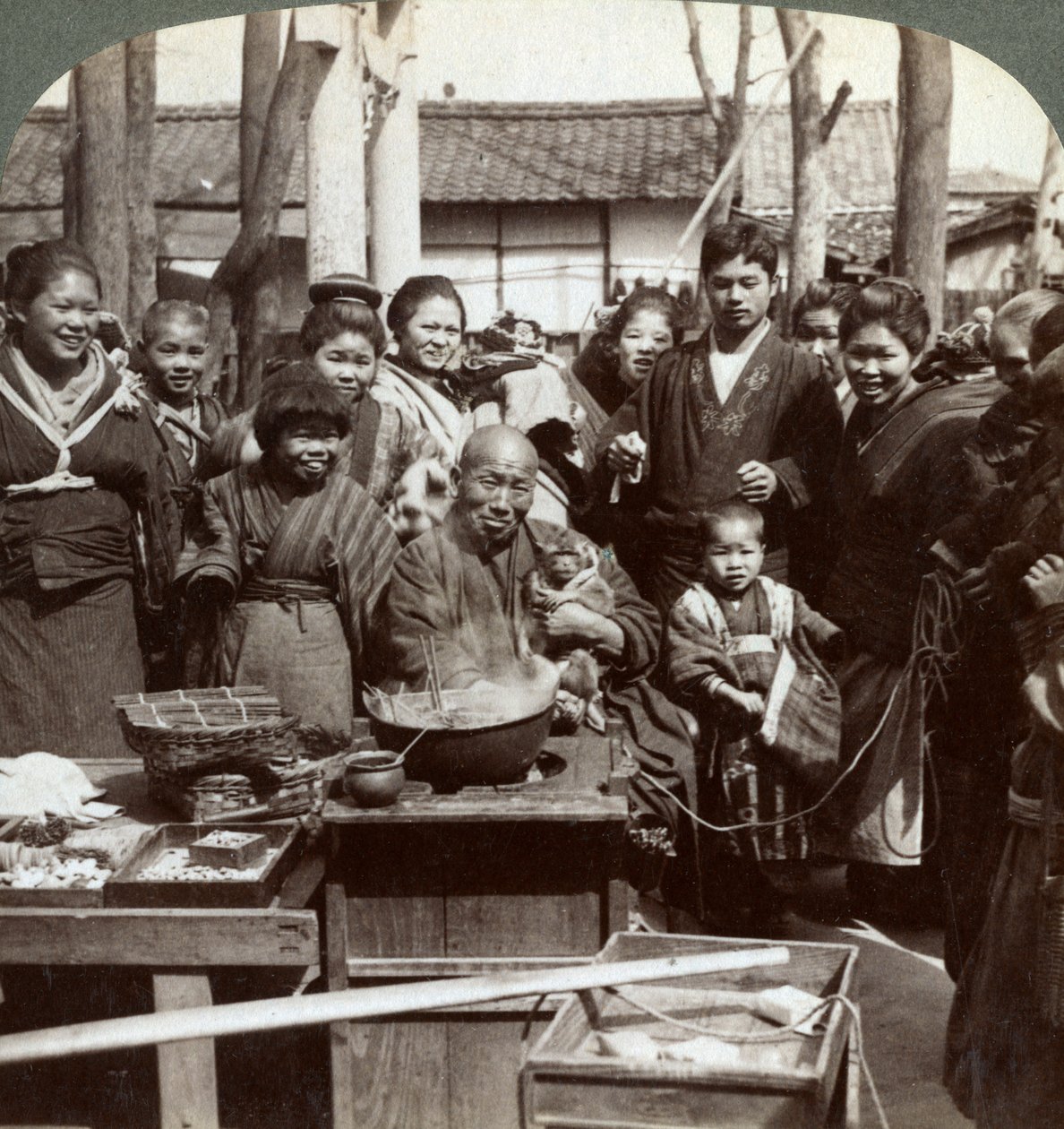 En gateartist med en ape som underholder publikum, Kobe, Japan, 1896. av Underwood and Underwood