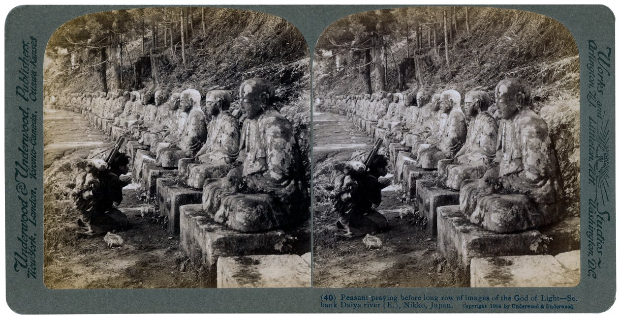 Bonde ber foran en rad med statuer av lysets Gud, Daiya-elven, Nikko, Japan, 1904. av Underwood and Underwood