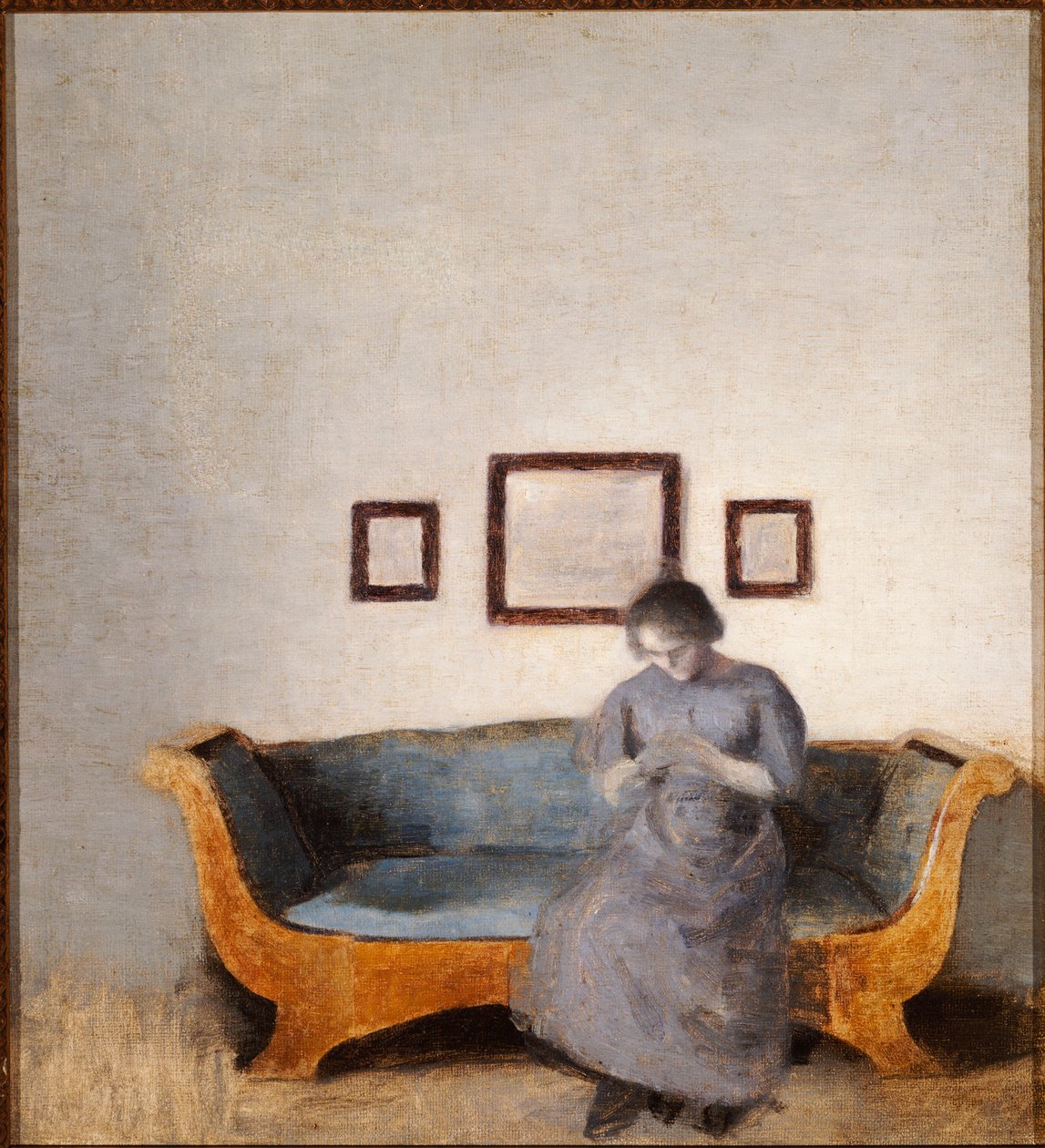 Ida Hammershoi sitter på en sofa av Vilhelm Hammershoi