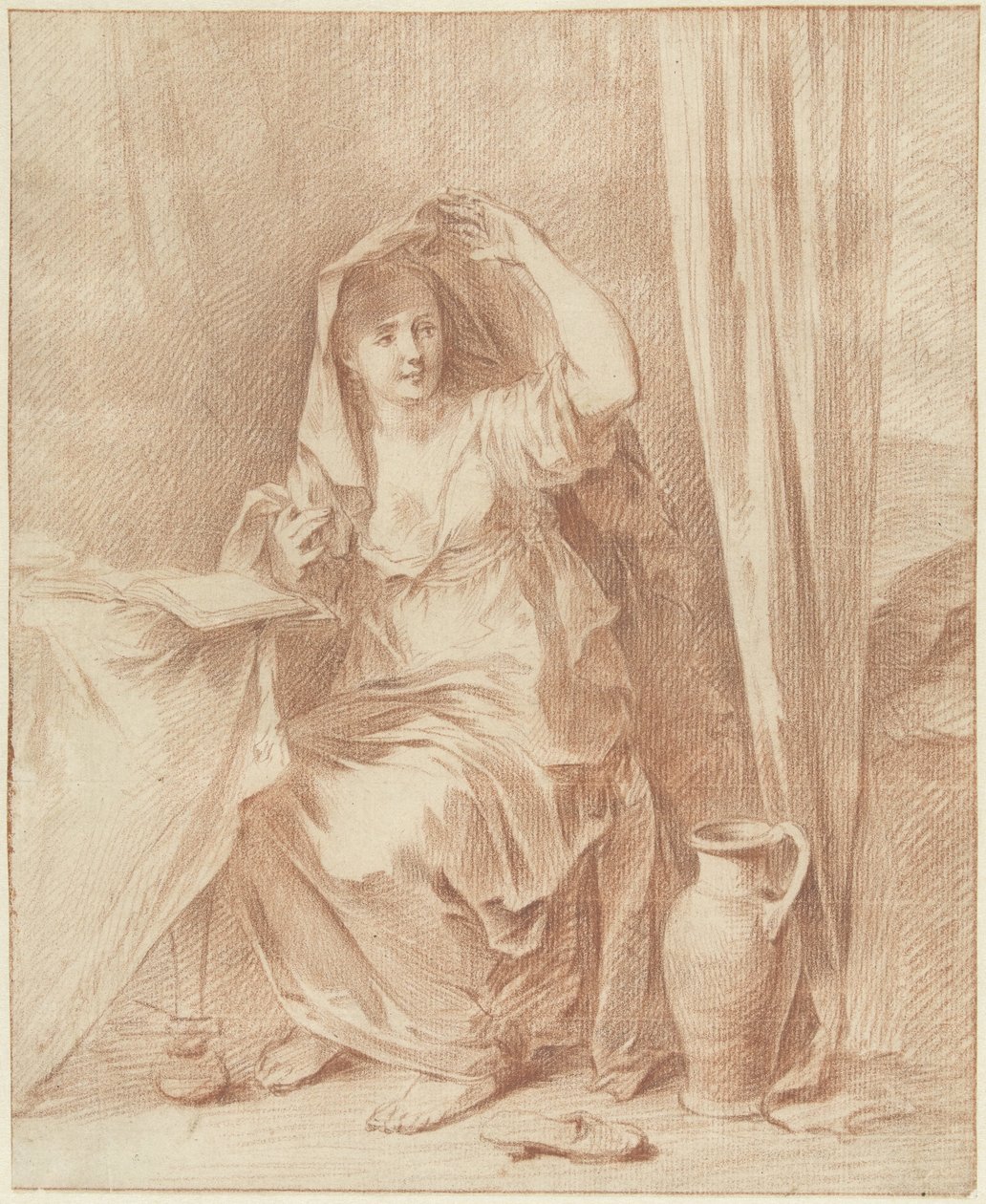 Kvinne sitter ved et bord bak en bok av Willem Joseph Laquy