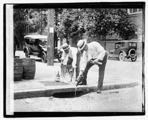To menn som heller brennevin i stormavløpet, 8. juli 1921 (s/hvitt-bilde) av American Photographer