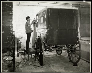 En mann som spraymaler en leveringsvogn fra Carolyn Laundry på 111 East 128th Street, East Harlem, New York, 1929 (sølv gelatintrykk) av Byron Company