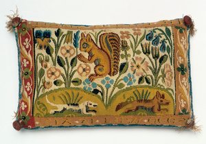 Et nålepute-teppepanel med et ekorn og motto "god vilje er alt" av English School