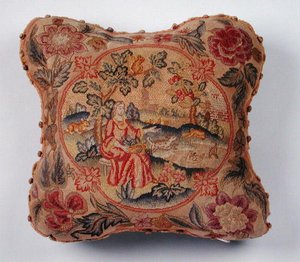 Pute, brodert i petit point, som viser en kvinne i et landskap (tekstil) av English School