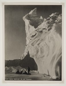 Hundeteam hviler ved et isfjell (bromidtrykk)