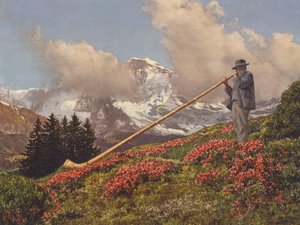 Sveits: An Alphorn Blower, Jungfrau i bakgrunnen (fargebilde)