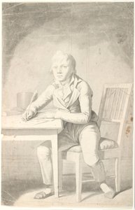 Ung skrivende gutt sitter ved et bord