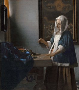 kvinne som holder en balanse av Johannes Vermeer