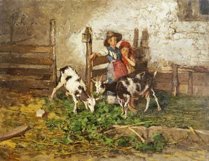 Barn og geiter i en låve,